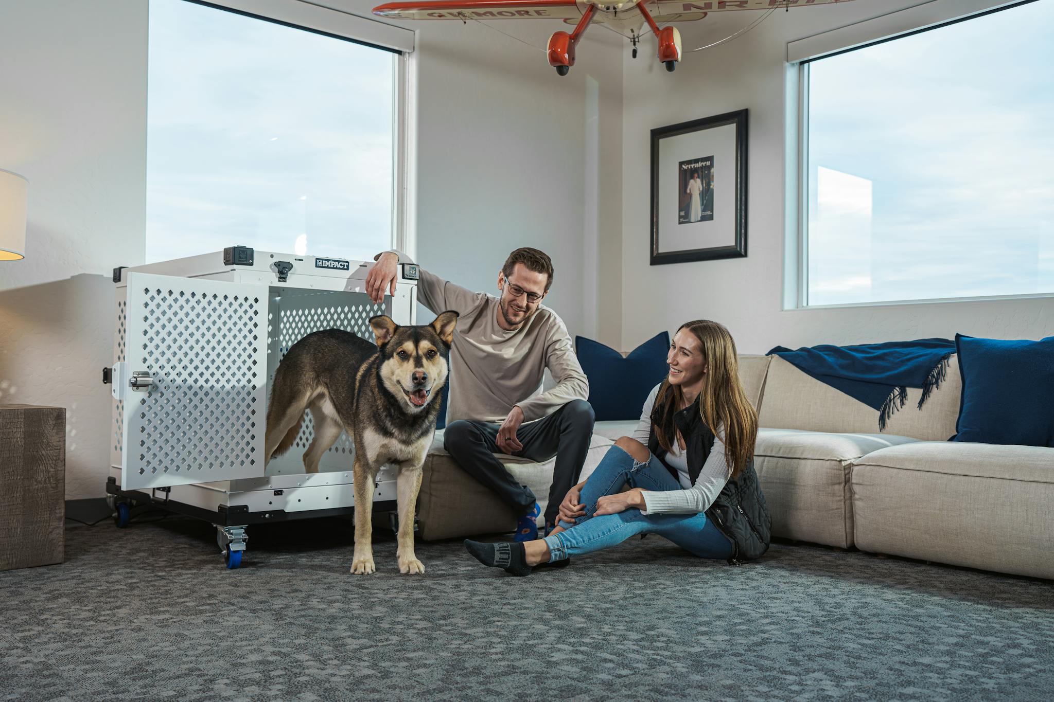 Cozy living room with couple and dog, showcasing comfort and pet-friendly lifestyle.